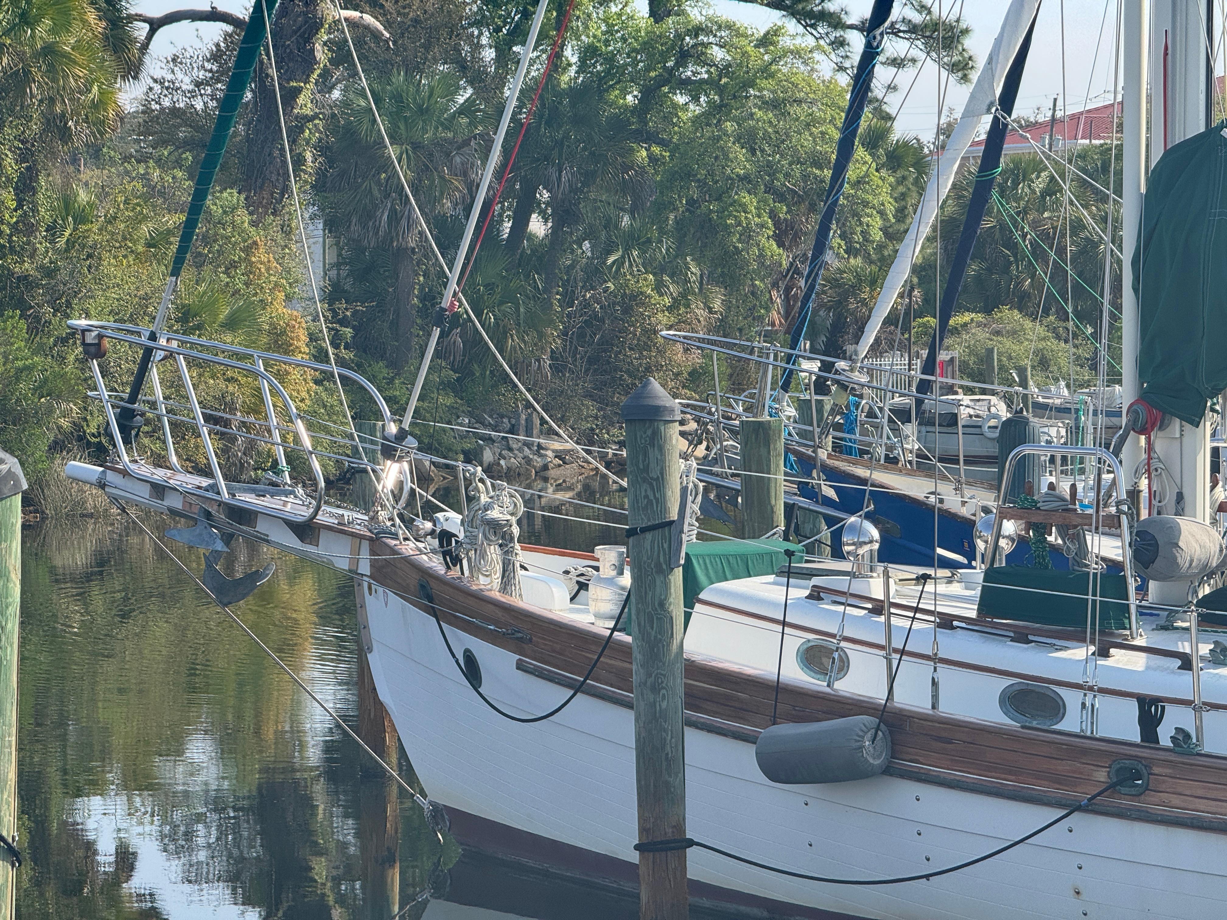 Sailboat Hans Christian 43T, 1989 model, docked in a serene marina setting.