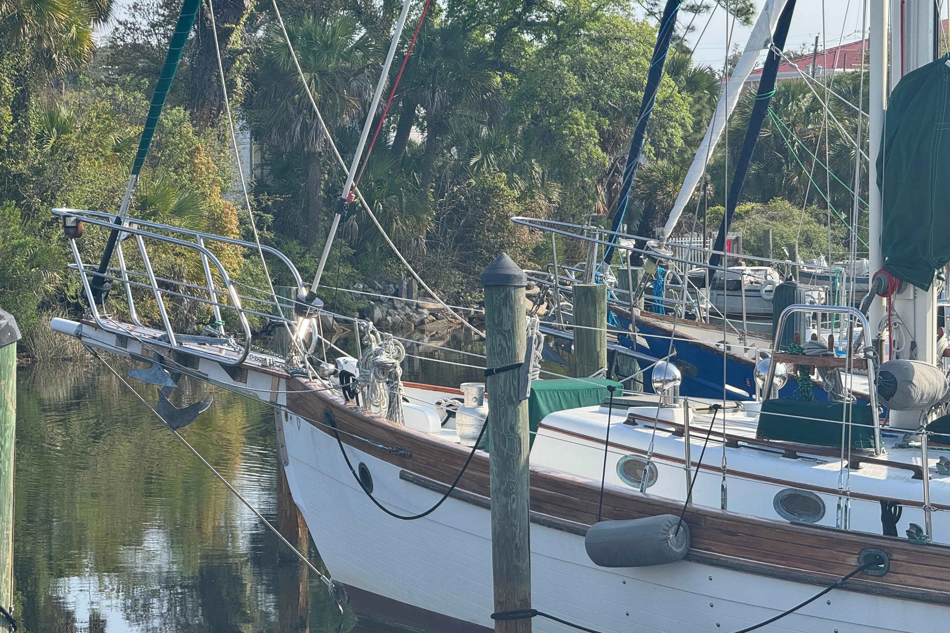 Sailboat Hans Christian 43T, 1989 model, docked in a serene marina setting.
