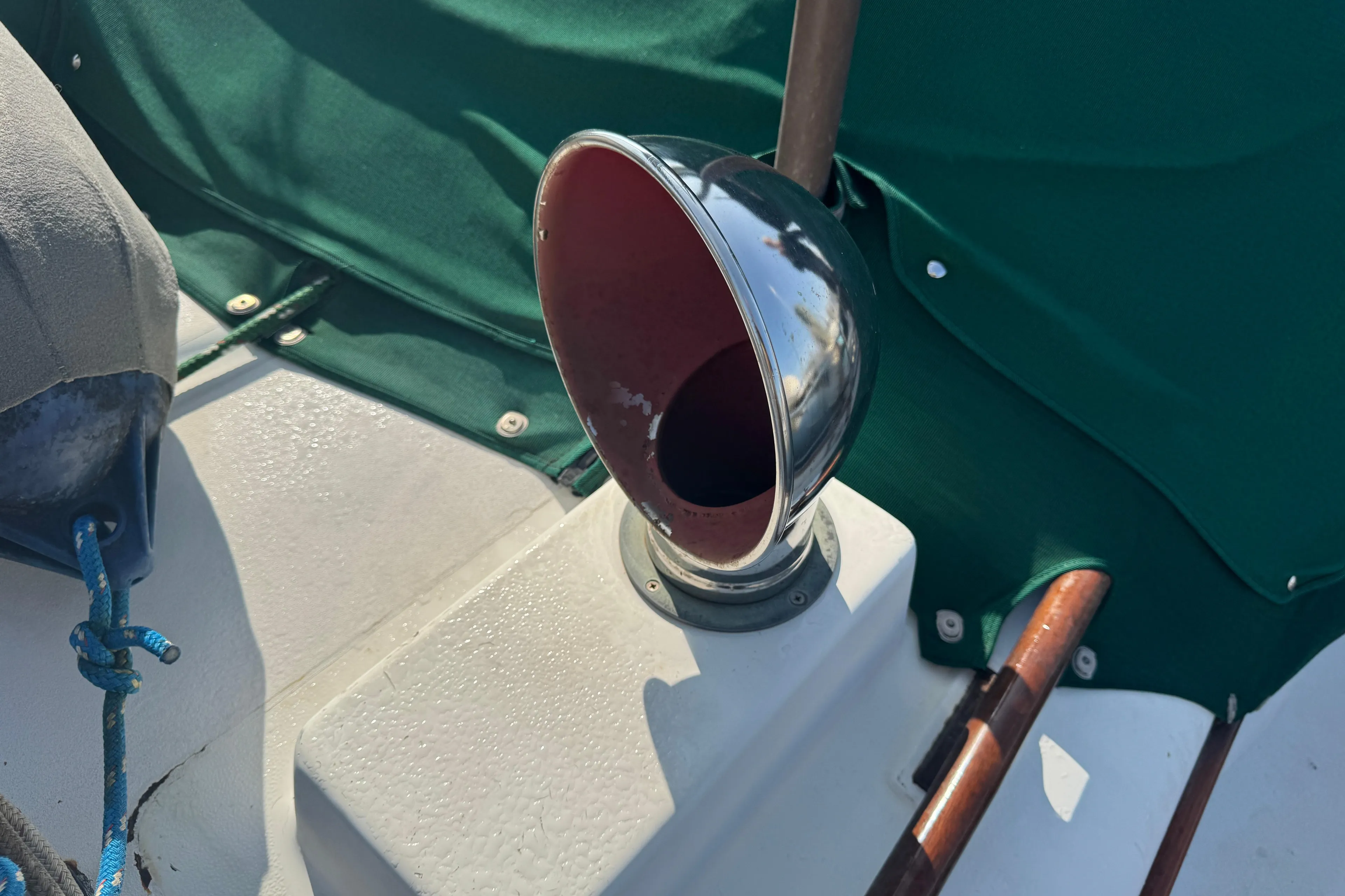1989 Hans Christian 43T sailboat deck with chrome vent and green canvas cover.
