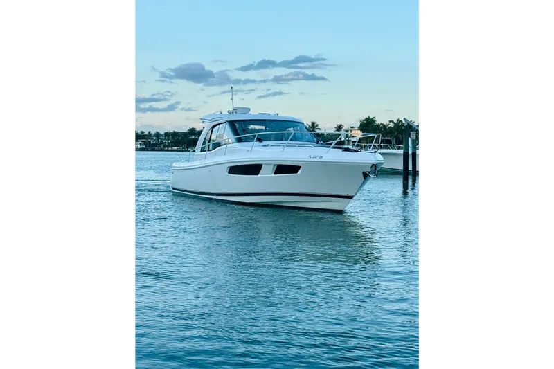  Yacht Photos Pics 2021 Intrepid 410 Evolution yacht on calm water at sunset.