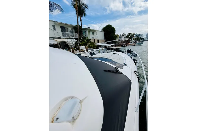  Yacht Photos Pics 2021 Intrepid 410 Evolution yacht docked by waterfront homes.