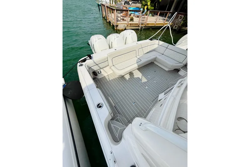  Yacht Photos Pics 2021 Intrepid 410 Evolution boat deck with seating, docked by clear water.