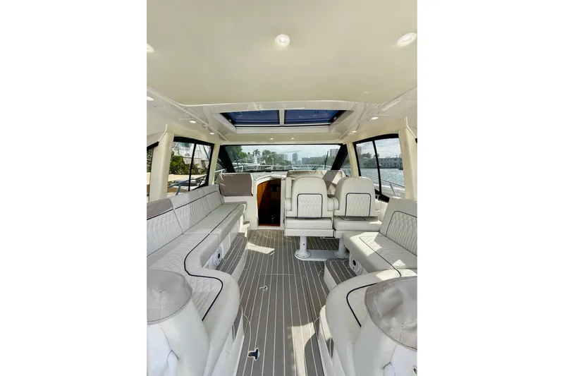  Yacht Photos Pics 2021 Intrepid 410 Evolution yacht interior with luxurious seating and panoramic windows.