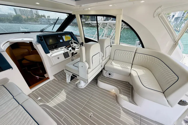  Yacht Photos Pics Luxurious interior of 2021 Intrepid 410 Evolution yacht with plush seating and modern helm.