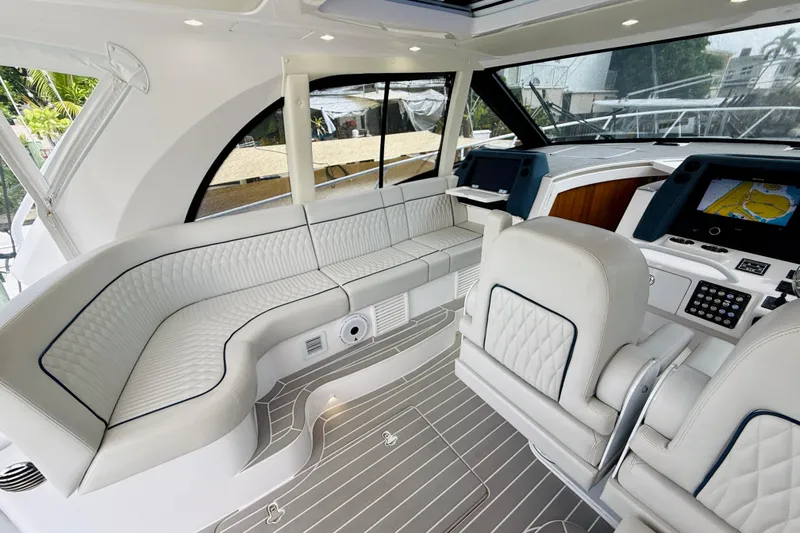  Yacht Photos Pics Luxurious interior of 2021 Intrepid 410 Evolution yacht with plush seating and advanced navigation systems.