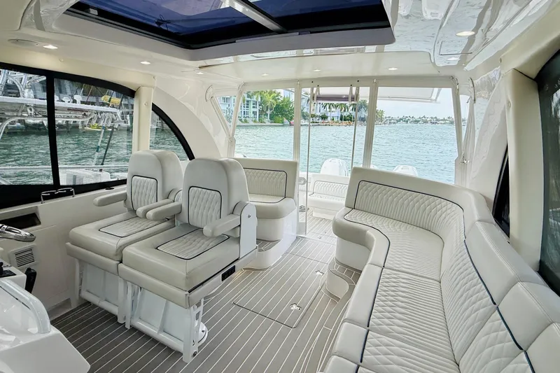  Yacht Photos Pics Luxurious interior of 2021 Intrepid 410 Evolution yacht with plush seating and scenic water view.