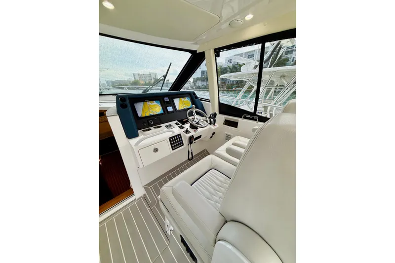  Yacht Photos Pics 2021 Intrepid 410 Evolution yacht helm with modern navigation displays and luxurious seating.