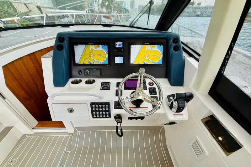  Yacht Photos Pics 2021 Intrepid 410 Evolution helm with dual navigation screens and modern controls.
