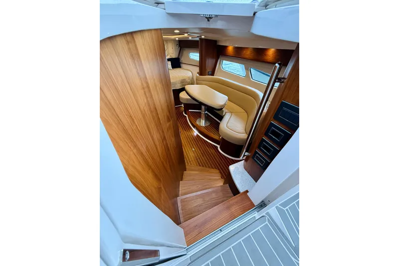  Yacht Photos Pics Luxurious interior of 2021 Intrepid 410 Evolution yacht with wooden finishes and plush seating.