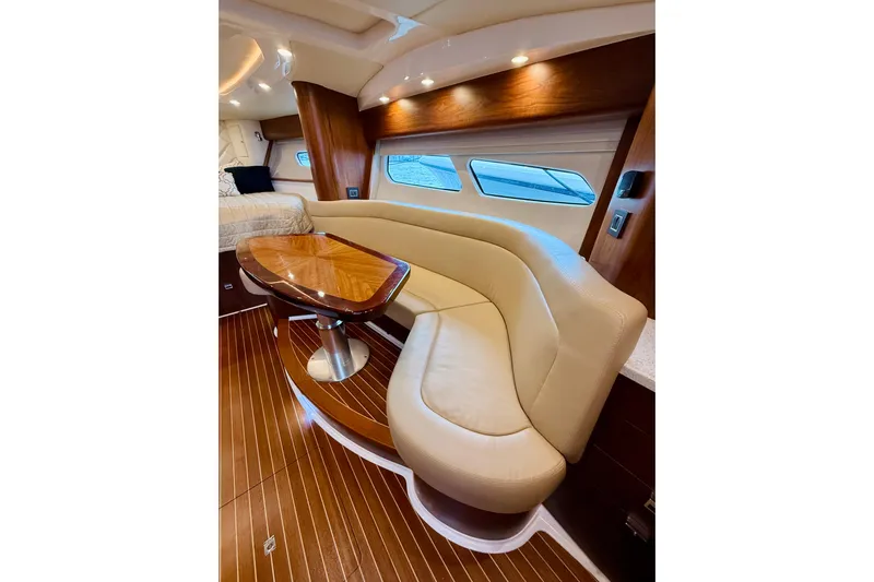  Yacht Photos Pics Luxurious interior of 2021 Intrepid 410 Evolution yacht with elegant seating and wooden table.
