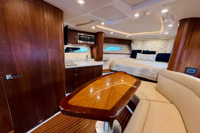  Yacht Photos Pics Luxurious interior of 2021 Intrepid 410 Evolution yacht with wood finishes and modern amenities.