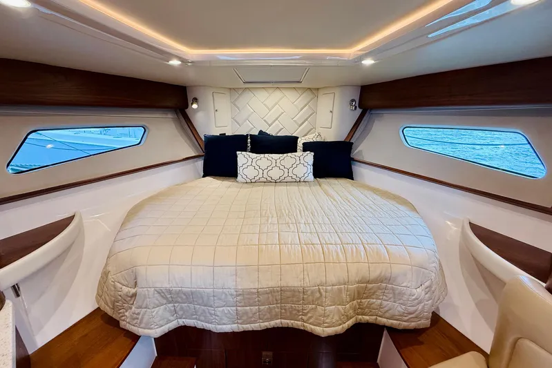 Yacht Photos Pics Luxurious cabin interior of 2021 Intrepid 410 Evolution yacht with cozy bedding.