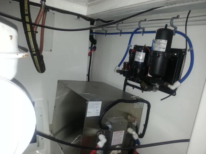  Yacht Photos Pics Engine room of a 2001 Cabo 35 Express boat, featuring mechanical components and wiring.