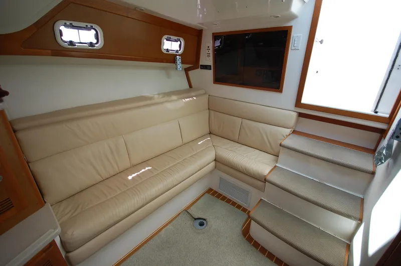  Yacht Photos Pics Interior of 2001 Cabo 35 Express yacht with beige seating and carpeted stairs.