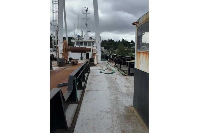  Yacht Photos Pics Deck view of a 1976 Halter Custom Built Mid-Water Trawler, featuring fishing equipment.