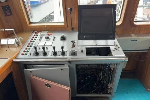  Yacht Photos Pics Control panel of a 1976 Halter Custom Built Mid-Water Trawler, featuring various switches and a monitor.