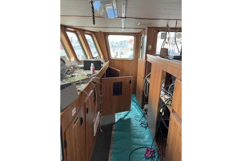  Yacht Photos Pics Interior of a 1976 Halter Custom Built Mid-Water Trawler, showing wooden cabinetry and equipment.