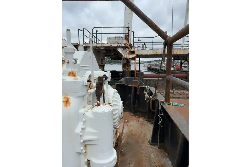  Yacht Photos Pics Rusty deck of a 1976 Halter Custom Built Mid-Water Trawler, showing machinery and railing.