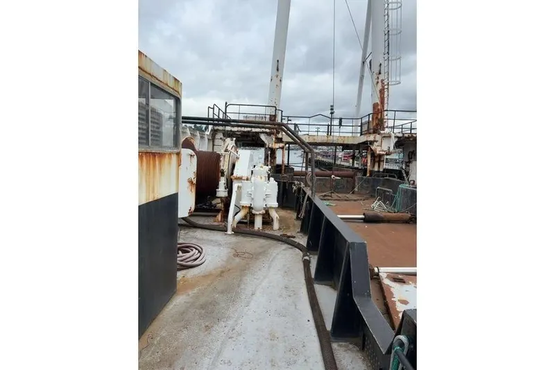  Yacht Photos Pics 1976 Halter Custom Built Mid-Water Trawler deck with equipment and rusted surfaces.