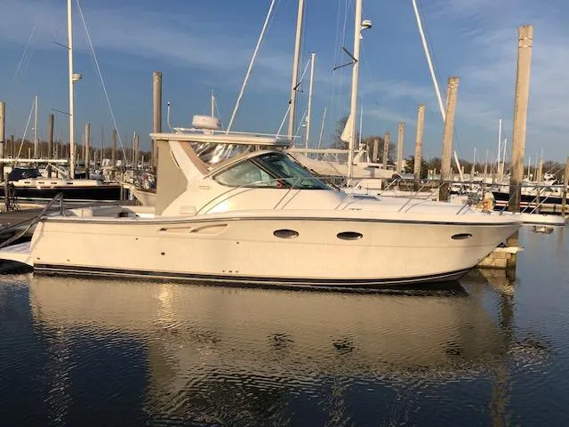 Mae Yacht Photos Pics 2005 Tiara Yachts 3200 docked in a marina, reflecting on calm water.