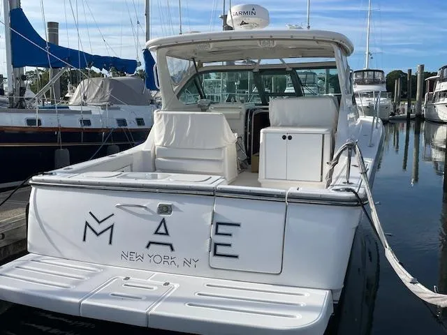Mae Yacht Photos Pics 2005 Tiara Yachts 3200 docked, rear view, with "MAE" and "New York, NY" on the stern.