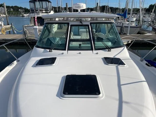 Mae Yacht Photos Pics 2005 Tiara Yachts 3200 at marina, showcasing sleek design and spacious deck.