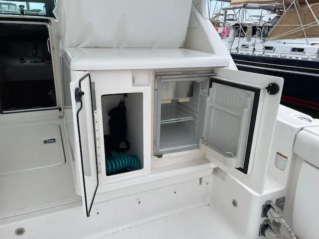Mae Yacht Photos Pics 2005 Tiara Yachts 3200 with open storage and refrigerator compartments on deck.