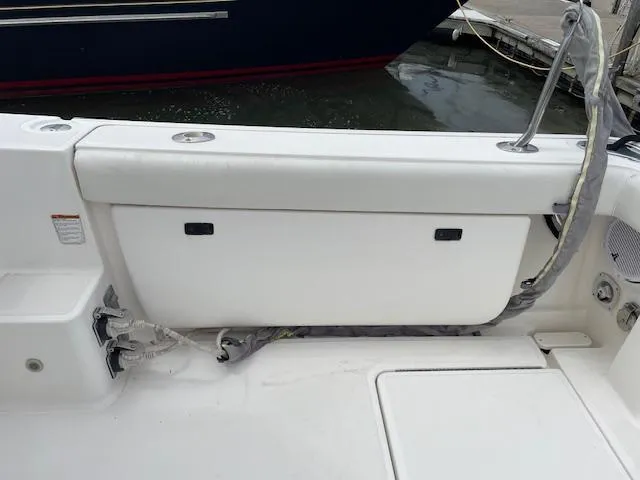 Mae Yacht Photos Pics 2005 Tiara Yachts 3200 boat deck with storage compartment and docked at marina.