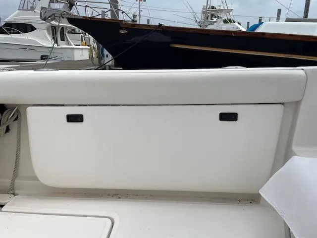 Mae Yacht Photos Pics 2005 Tiara Yachts 3200 boat deck with storage compartment, docked at marina.