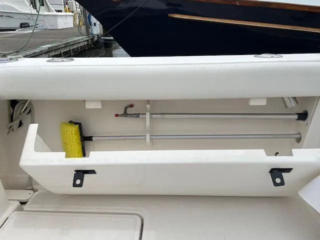 Mae Yacht Photos Pics Storage compartment on a 2005 Tiara Yachts 3200, featuring cleaning tools and equipment.