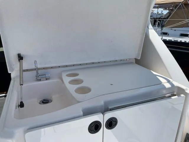 Mae Yacht Photos Pics 2005 Tiara Yachts 3200 wet bar with sink and cup holders on deck.