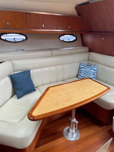 Mae Yacht Photos Pics 2005 Tiara Yachts 3200 interior with elegant seating and wooden table.