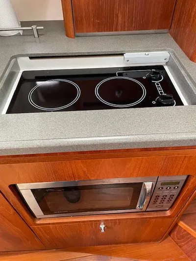 Mae Yacht Photos Pics 2005 Tiara Yachts 3200 kitchen with stovetop and microwave.