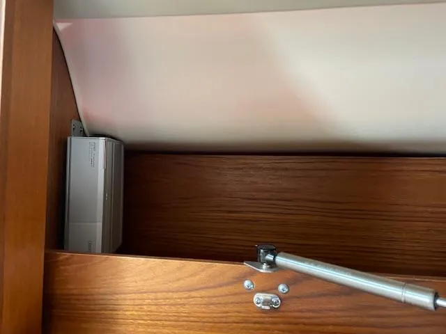 Mae Yacht Photos Pics Wooden cabinet interior on a 2005 Tiara Yachts 3200, featuring a hydraulic hinge.