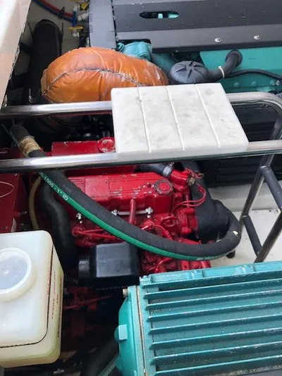 Mae Yacht Photos Pics Engine compartment of a 2005 Tiara Yachts 3200, featuring red and teal components.