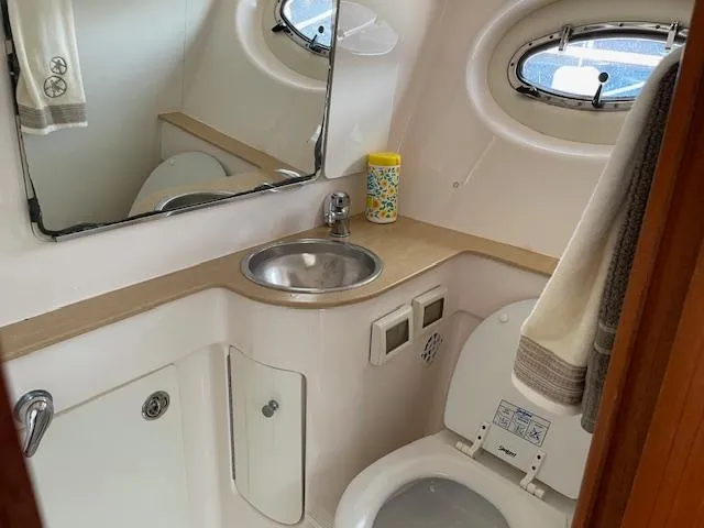 Mae Yacht Photos Pics 2005 Tiara Yachts 3200 bathroom with sink, mirror, and toilet.