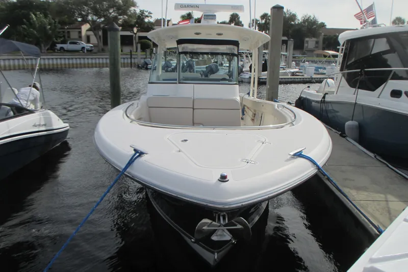  Yacht Photos Pics 2013 Pursuit ST 310 Sport boat docked at marina, front view.