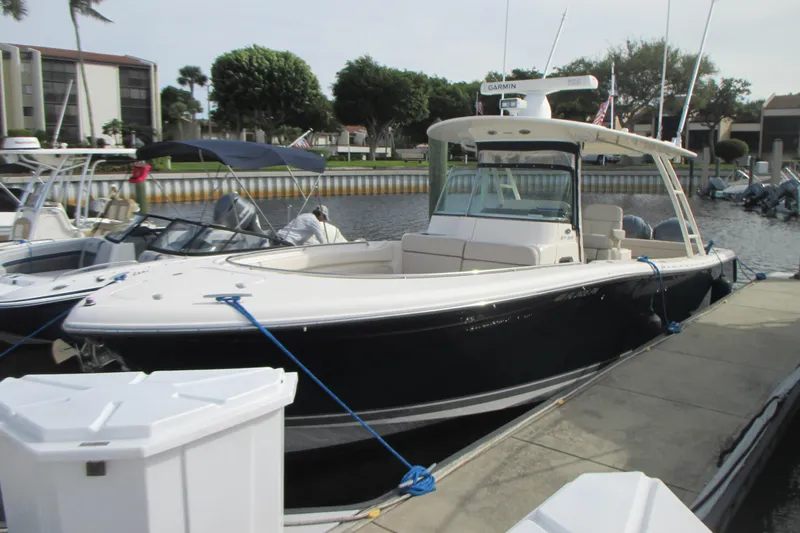  Yacht Photos Pics 2013 Pursuit ST 310 Sport boat docked at marina, featuring sleek design and modern amenities.