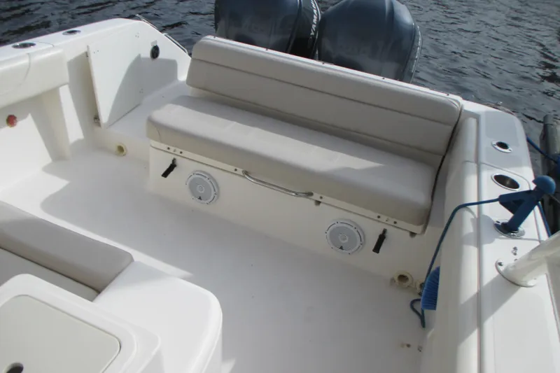  Yacht Photos Pics 2013 Pursuit ST 310 Sport boat interior with cushioned seating and dual engines.