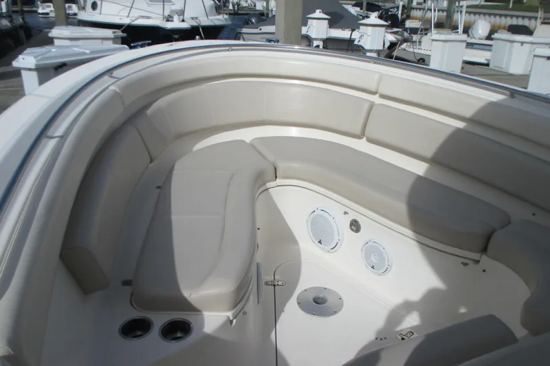  Yacht Photos Pics 2013 Pursuit ST 310 Sport boat interior with cushioned seating and speakers.