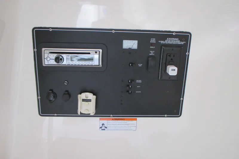  Yacht Photos Pics Control panel of a 2013 Pursuit ST 310 Sport boat with various switches and outlets.