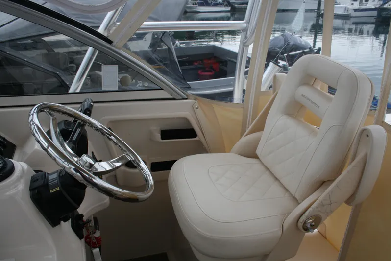  Yacht Photos Pics 2020 Grady-White Gulfstream 232 boat interior with steering wheel and cushioned seat.