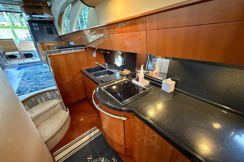  Yacht Photos Pics Luxurious kitchen interior of a 2006 Azimut 50 yacht with sleek wooden cabinetry.