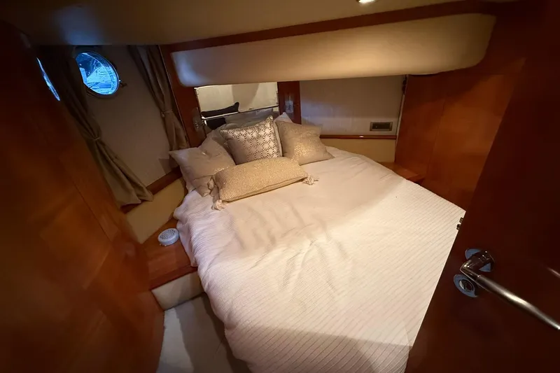  Yacht Photos Pics Luxurious bedroom interior of a 2006 Azimut 50 yacht with elegant bedding.