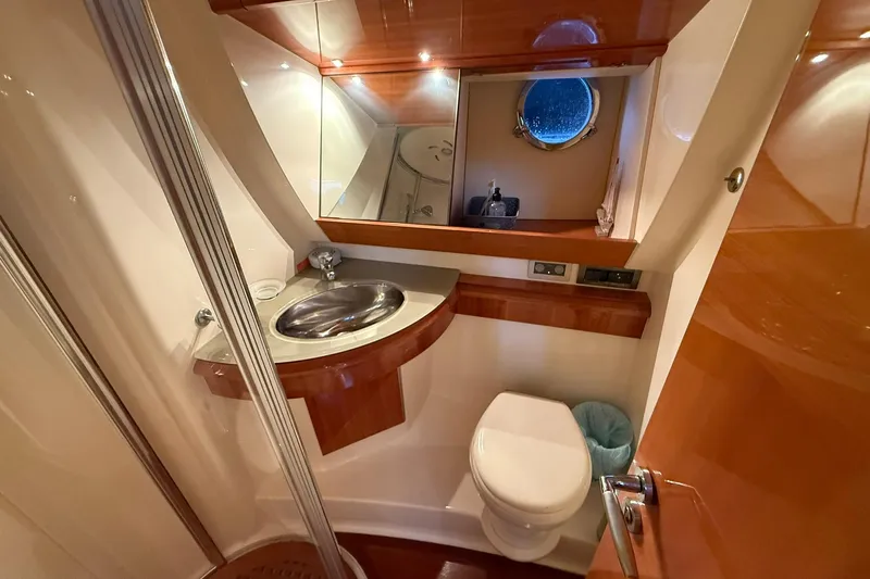  Yacht Photos Pics Luxurious bathroom interior of 2006 Azimut 50 yacht with modern fixtures and porthole.