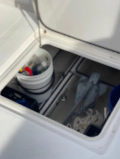  Yacht Photos Pics Storage compartment on a 2013 Bahama 41 Open boat with buckets and equipment.