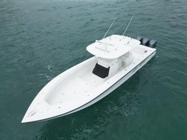  Yacht Photos Pics 2013 Bahama 41 Open boat on water, featuring sleek design and multiple outboard engines.