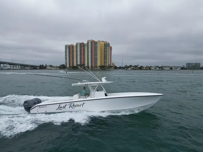 Yacht Photos Pics 2013 Bahama 41 Open boat cruising near coastal buildings under cloudy skies.