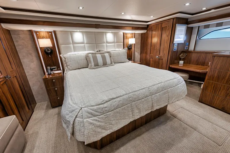 Lucky Wave Yacht Photos Pics Luxurious bedroom interior of 2021 Viking 80 Convertible yacht with elegant wood finishes.
