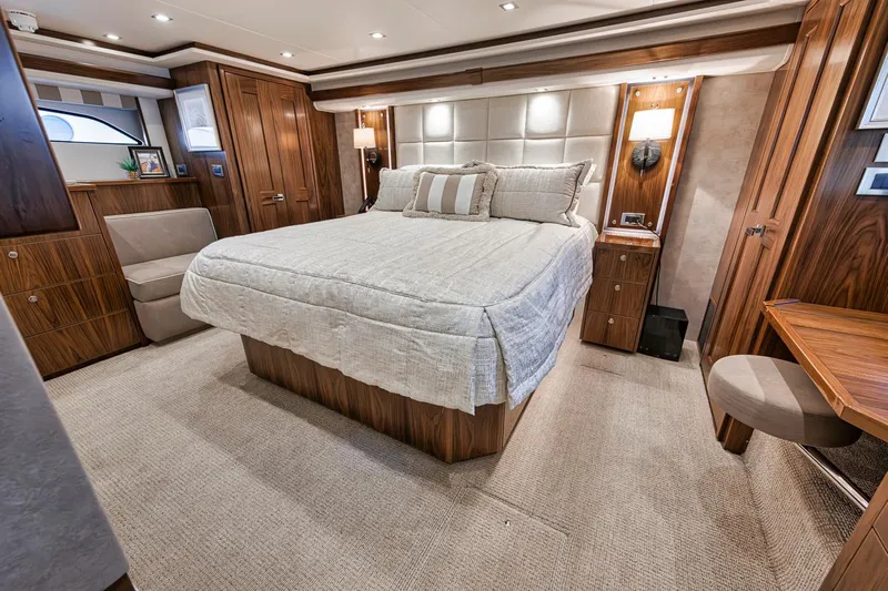 Lucky Wave Yacht Photos Pics Luxurious bedroom interior of 2021 Viking 80 Convertible yacht with elegant wood finishes.